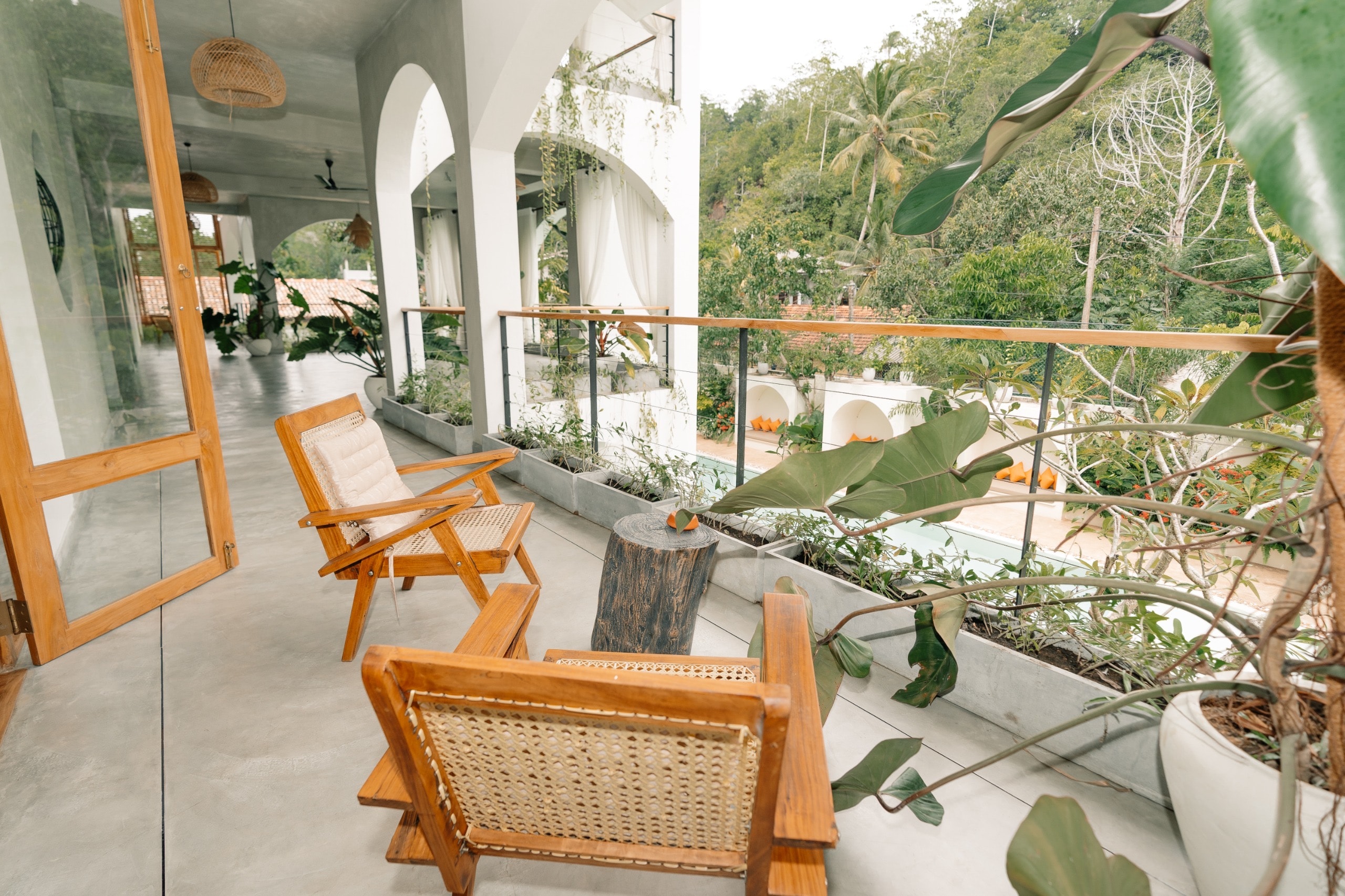 Balcony with teak chairs overlooking pool and jungle, Sri Lanka wellness retreat